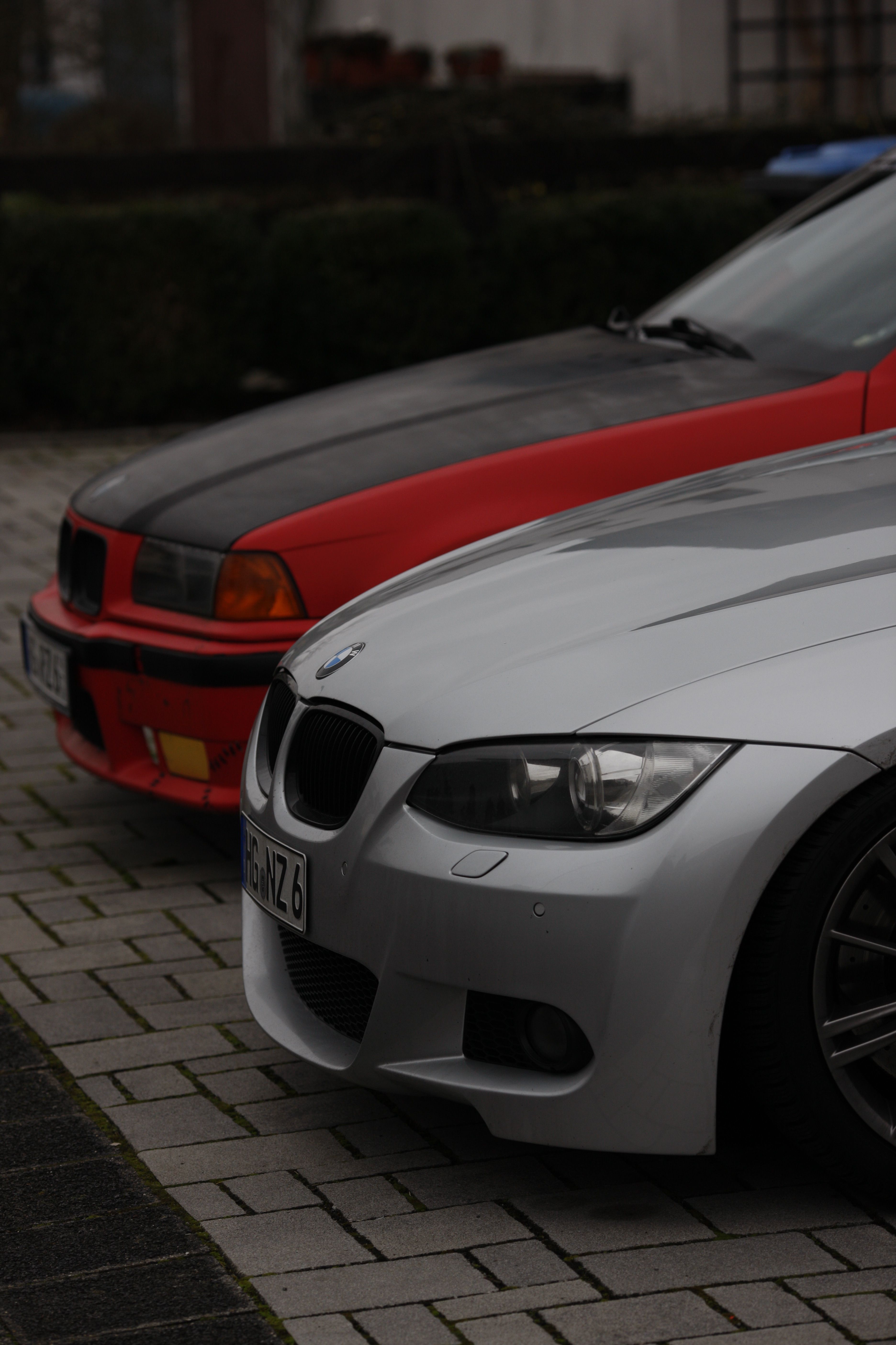 Close-up view of two parked BMW cars showcasing luxury and design.