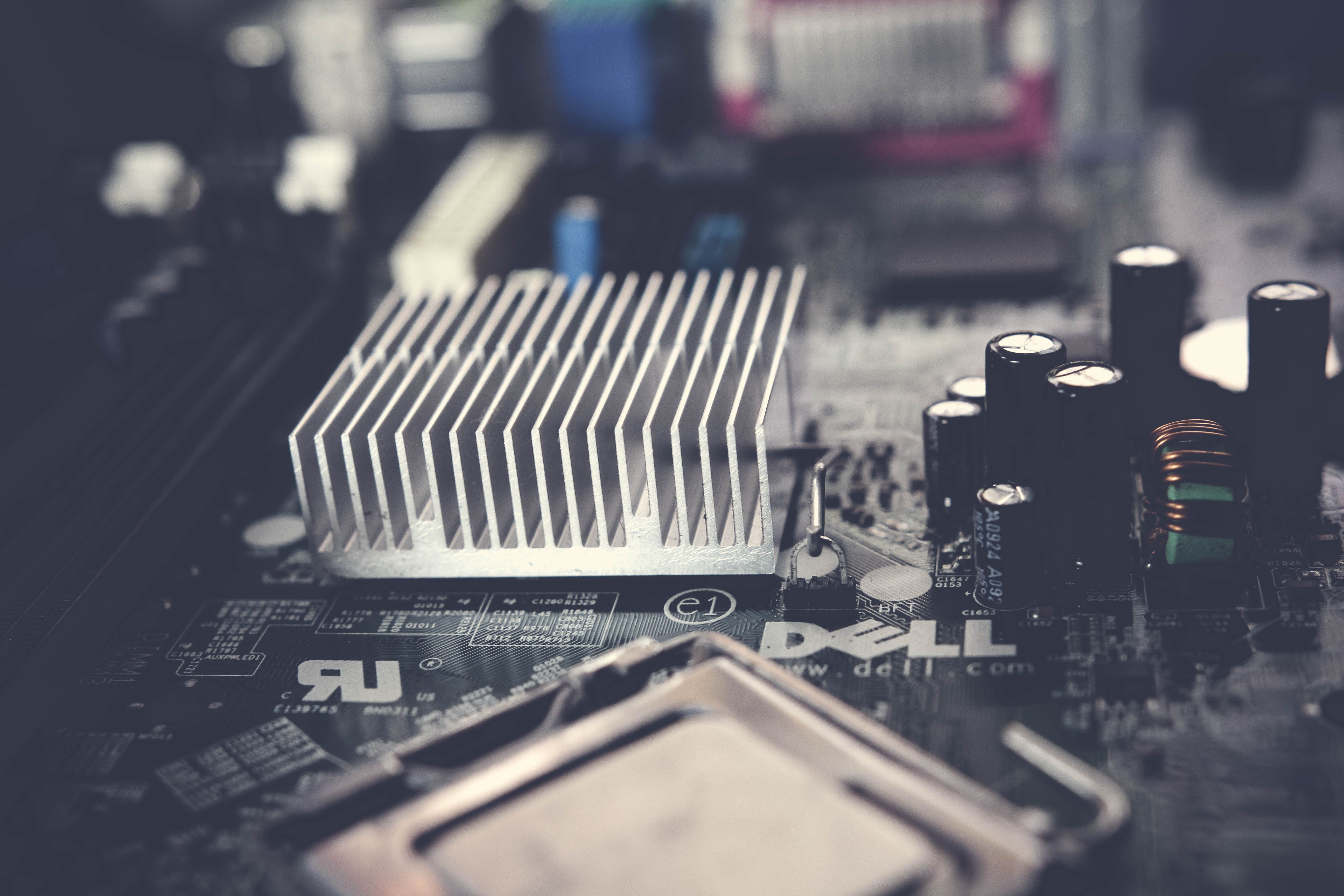 Detailed view of a computer motherboard featuring a heatsink and electronic components, showcasing modern technology.