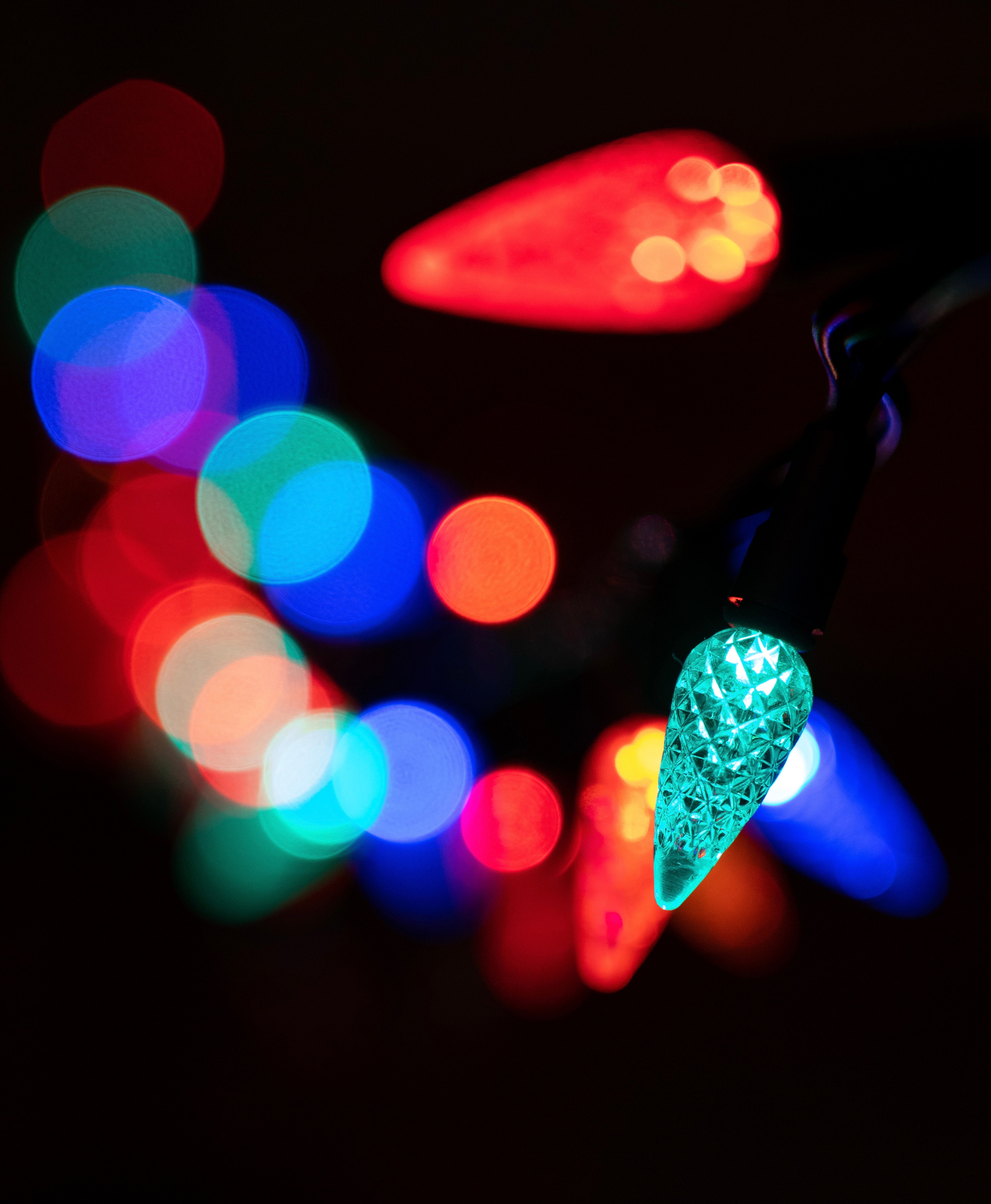 Close-up of vibrant multicolored holiday lights with a vivid bokeh effect.