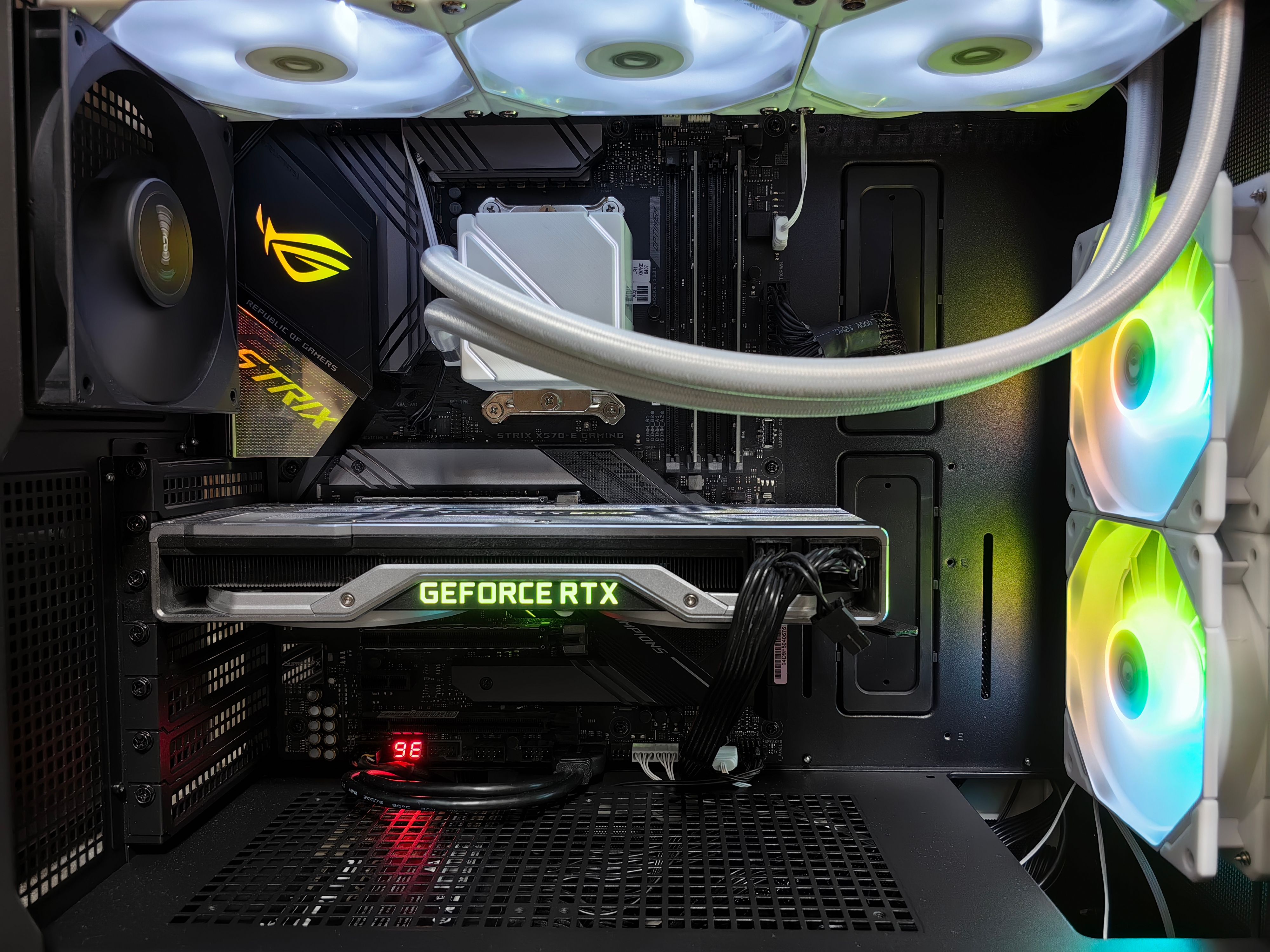 Detailed view of a gaming PC build featuring a GeForce RTX graphics card and RGB lighting in a sleek black case.