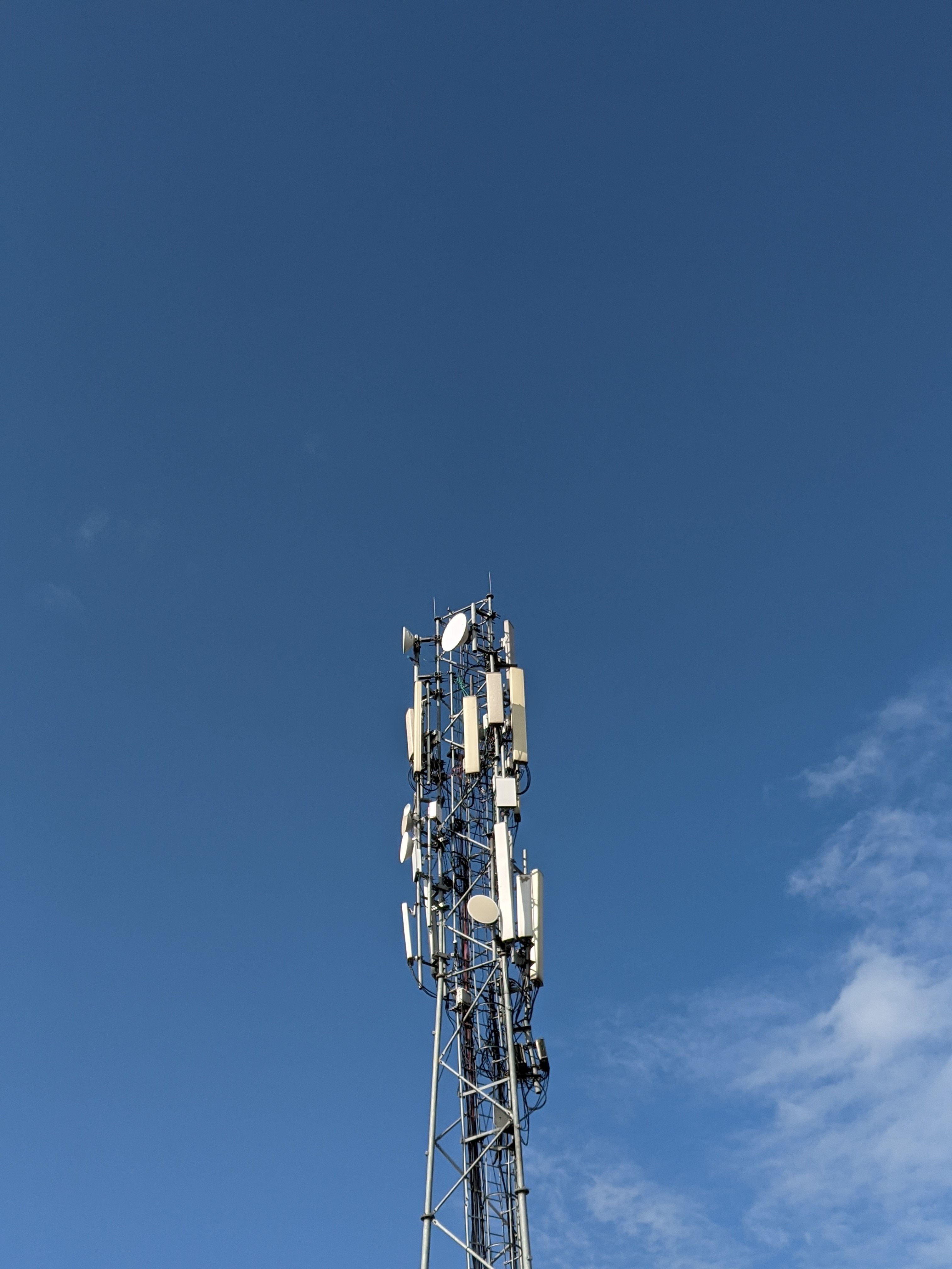 A telecommunication tower reaching into the clear blue sky in Tanda, UP, India.