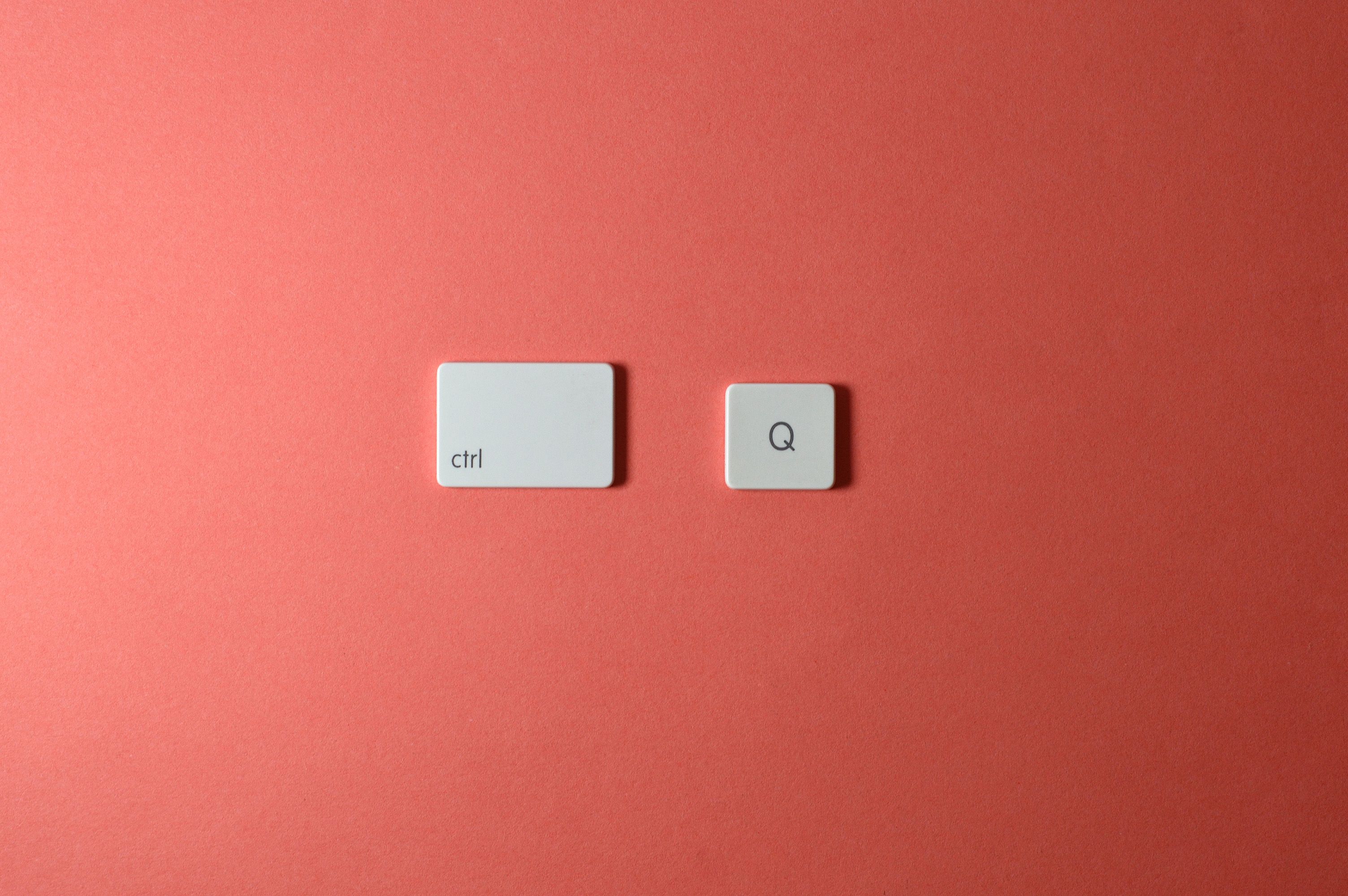 Two keyboard keys on a red surface, highlighting a minimalist tech concept.