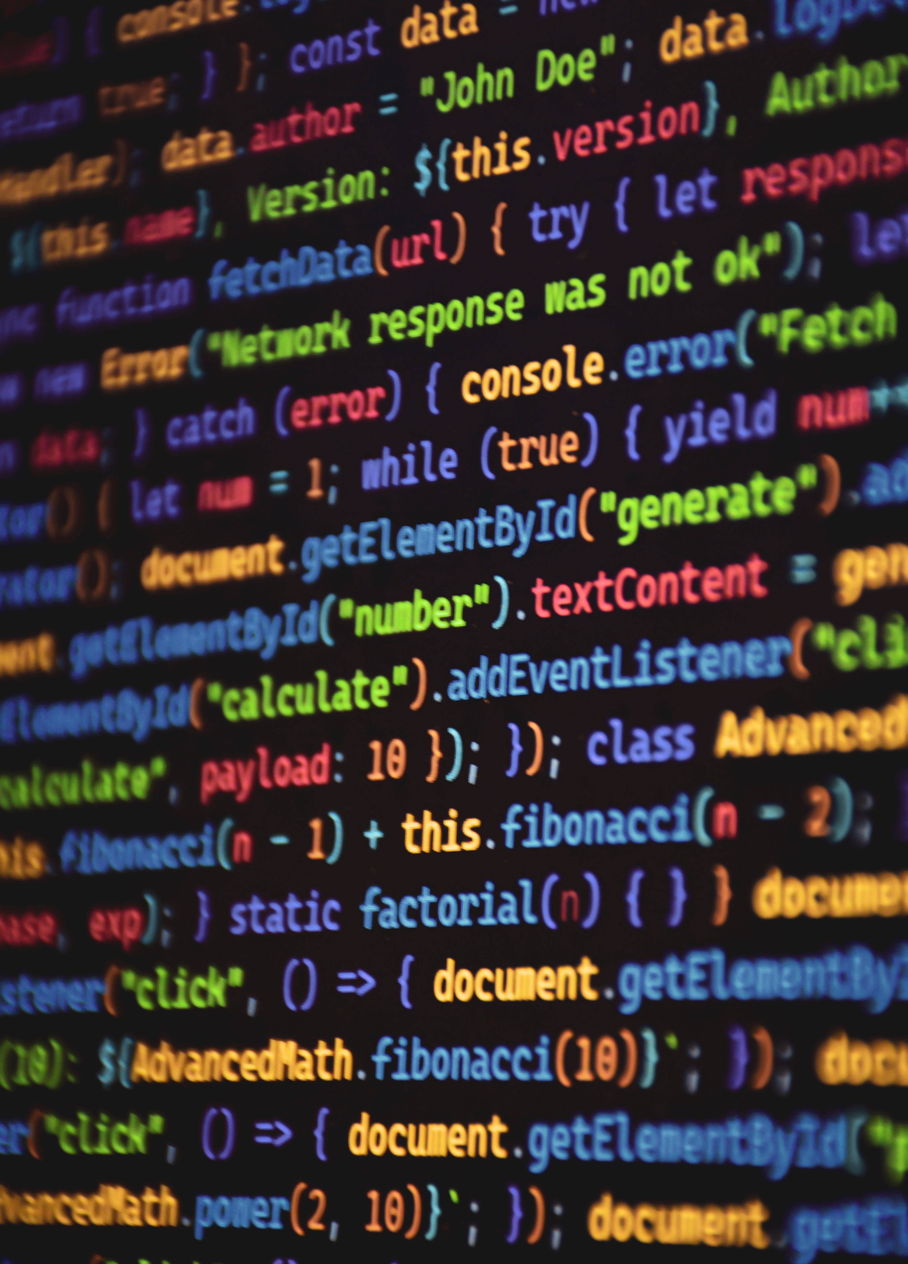 Close-up of vibrant colored JavaScript code showing functions and syntax on a dark screen.