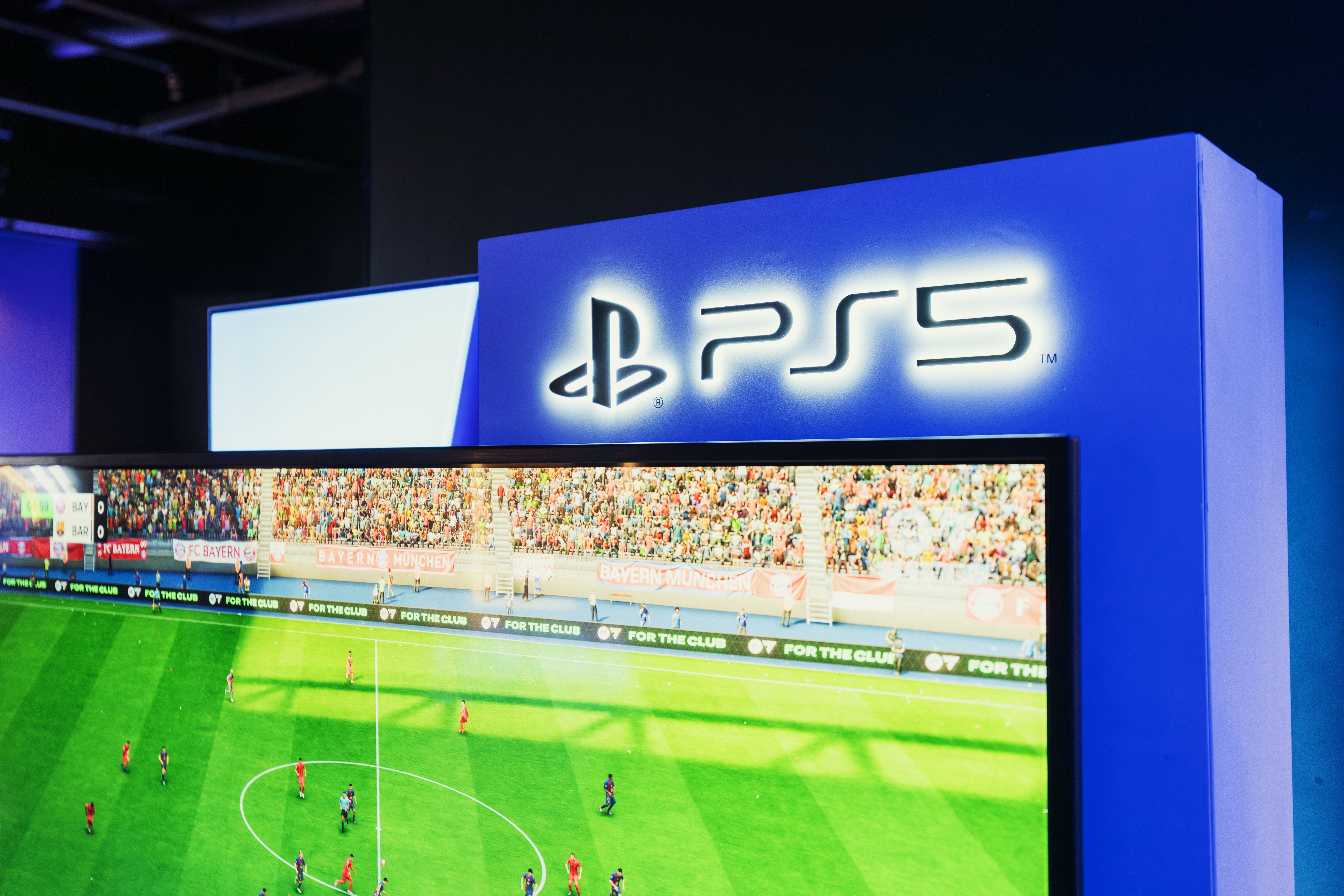 PS5 gaming station featuring a live soccer match onscreen, showcasing high-quality graphics.