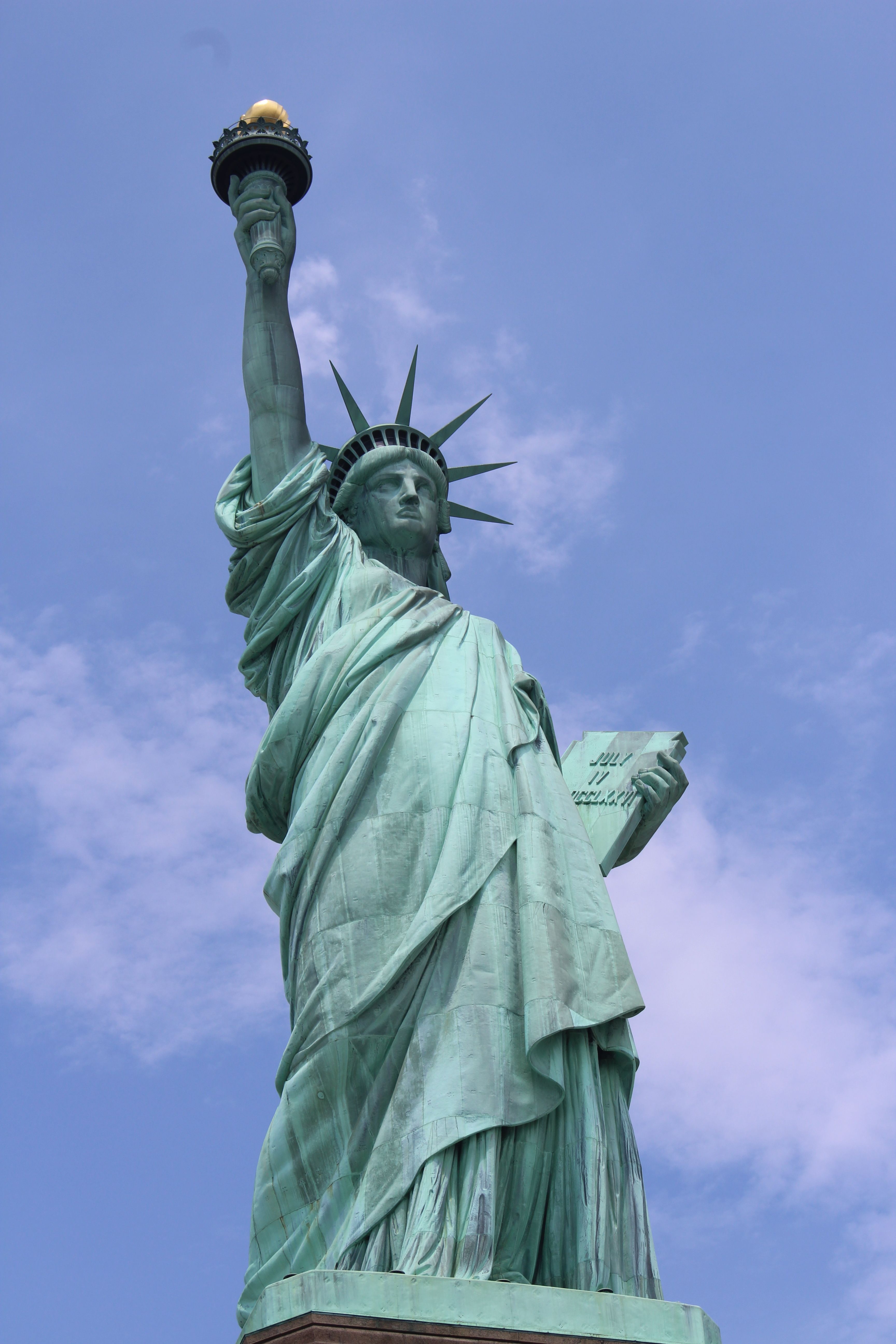 Iconic Statue of Liberty under a serene blue sky in New York City.
