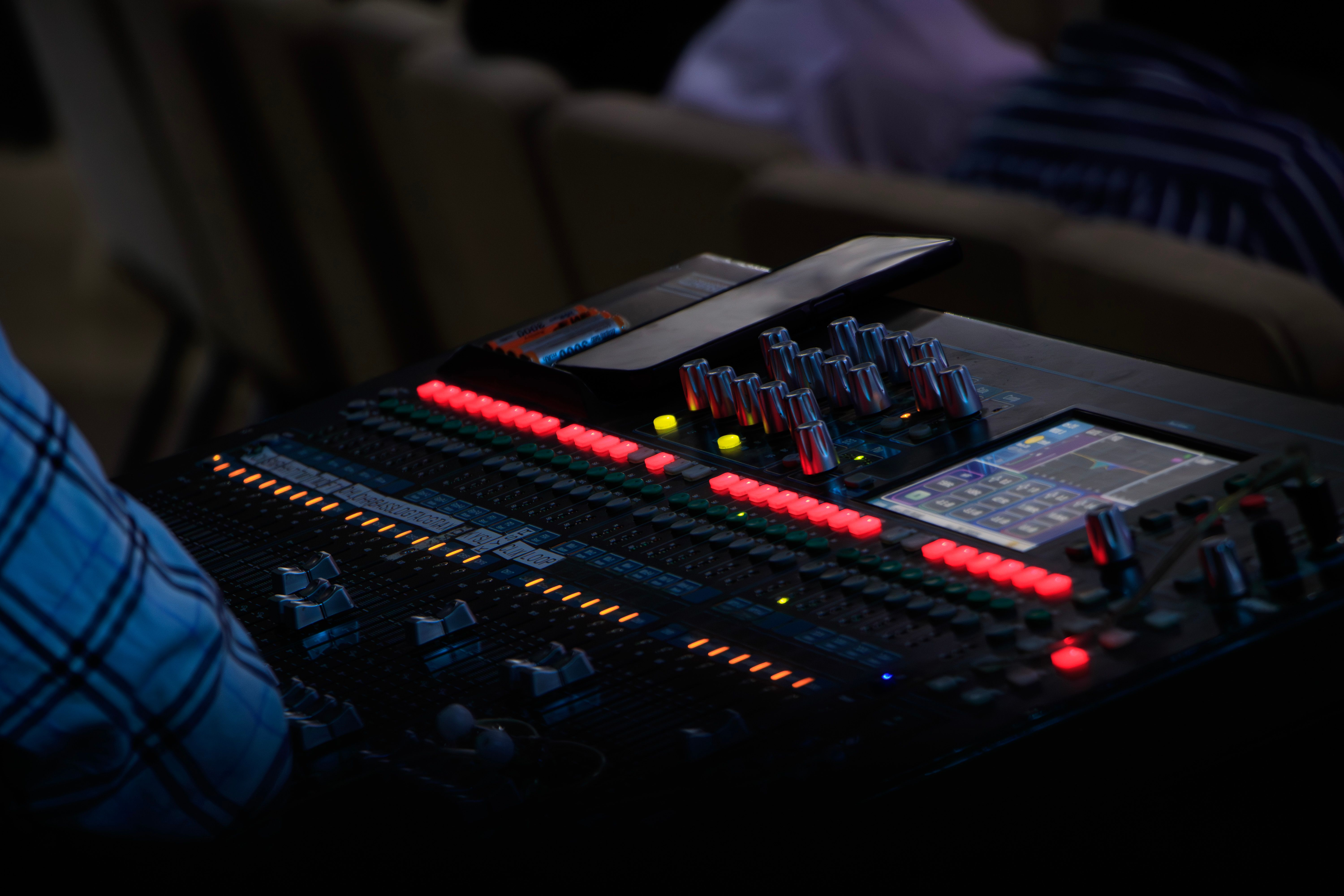 Detailed view of an audio mixer with colorful lights at a live music event in Nairobi, Kenya.