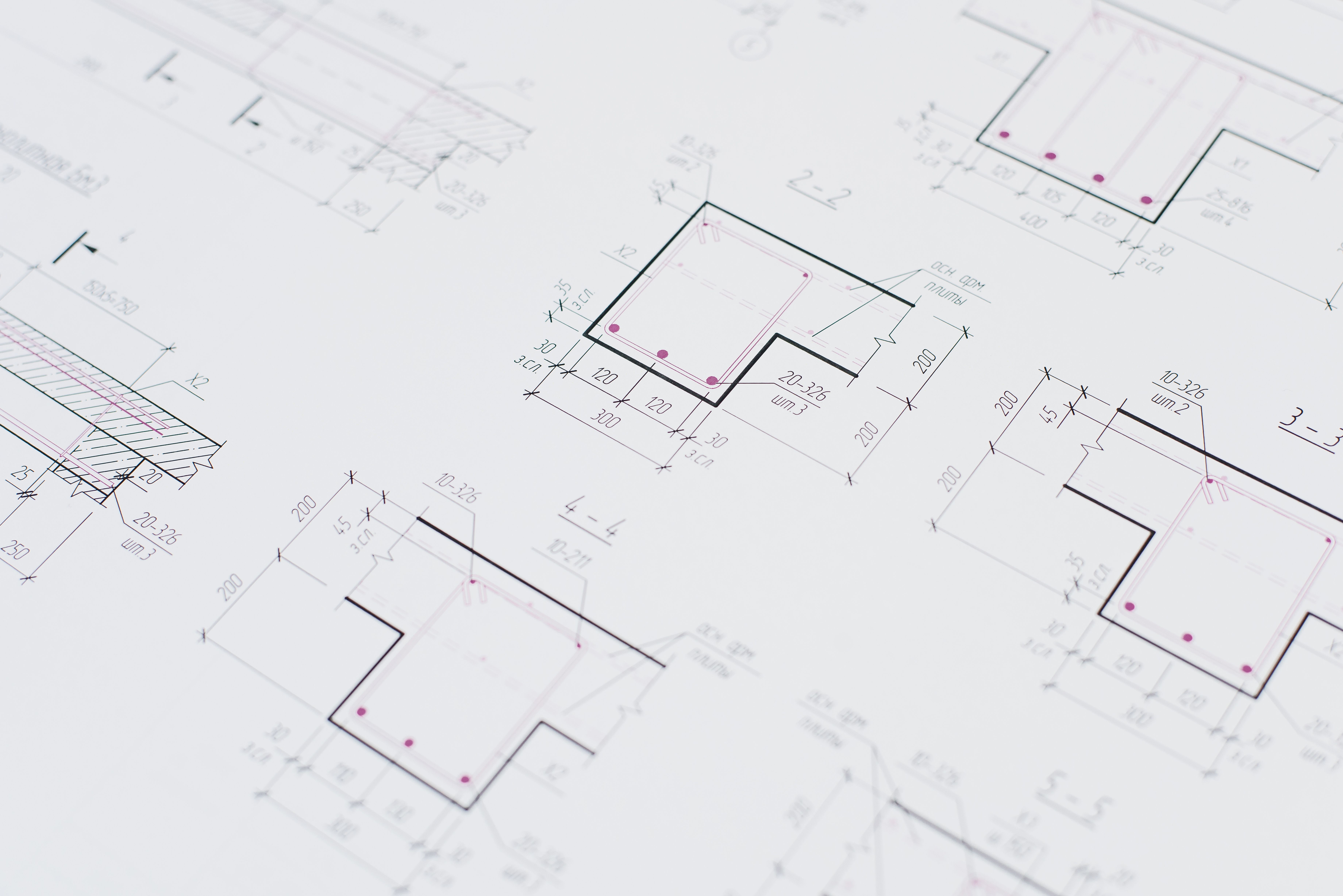 High-resolution close-up of detailed architectural blueprints showcasing precision design layouts.