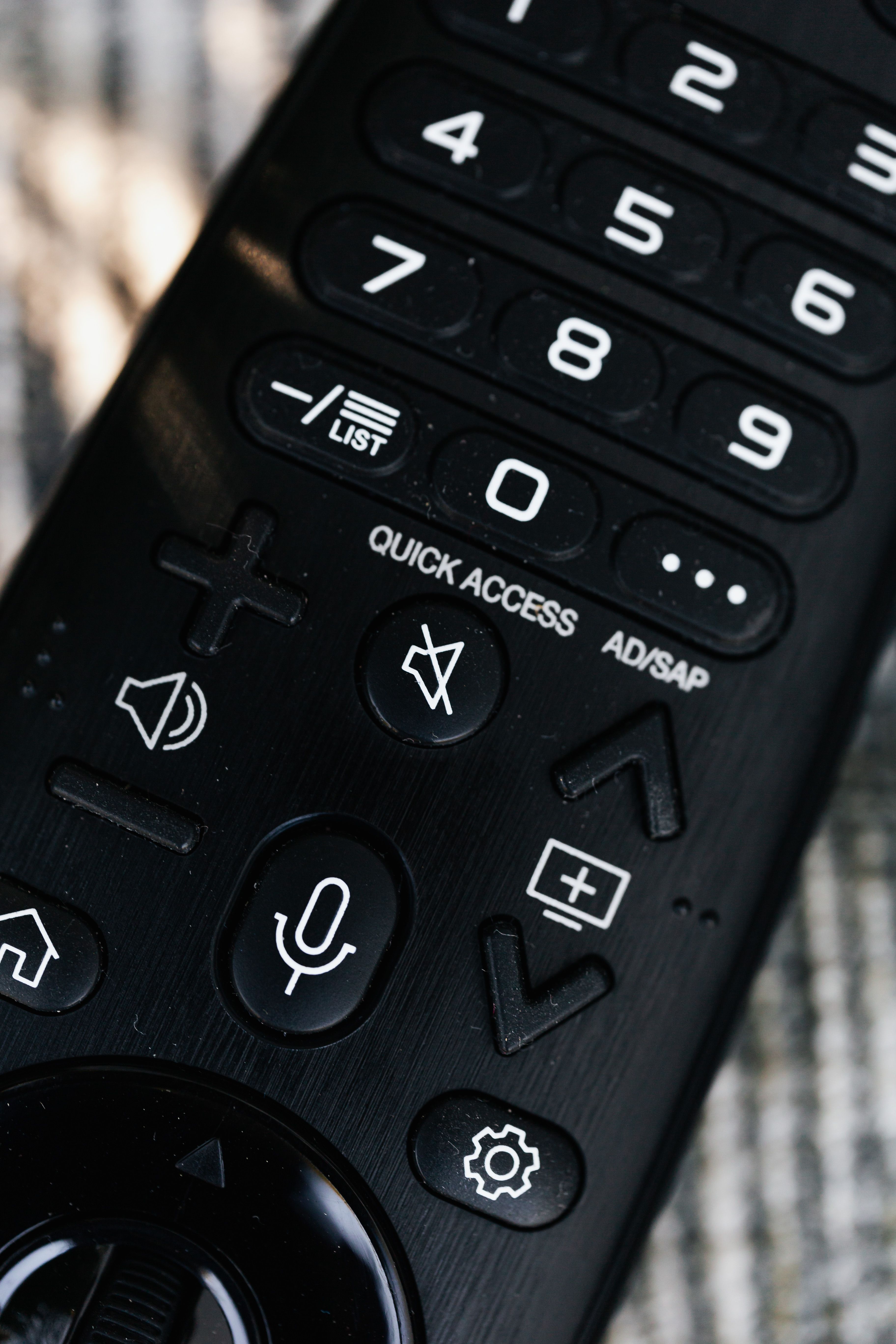 Detailed view of a remote control featuring buttons with numbers and symbols, emphasizing usage.