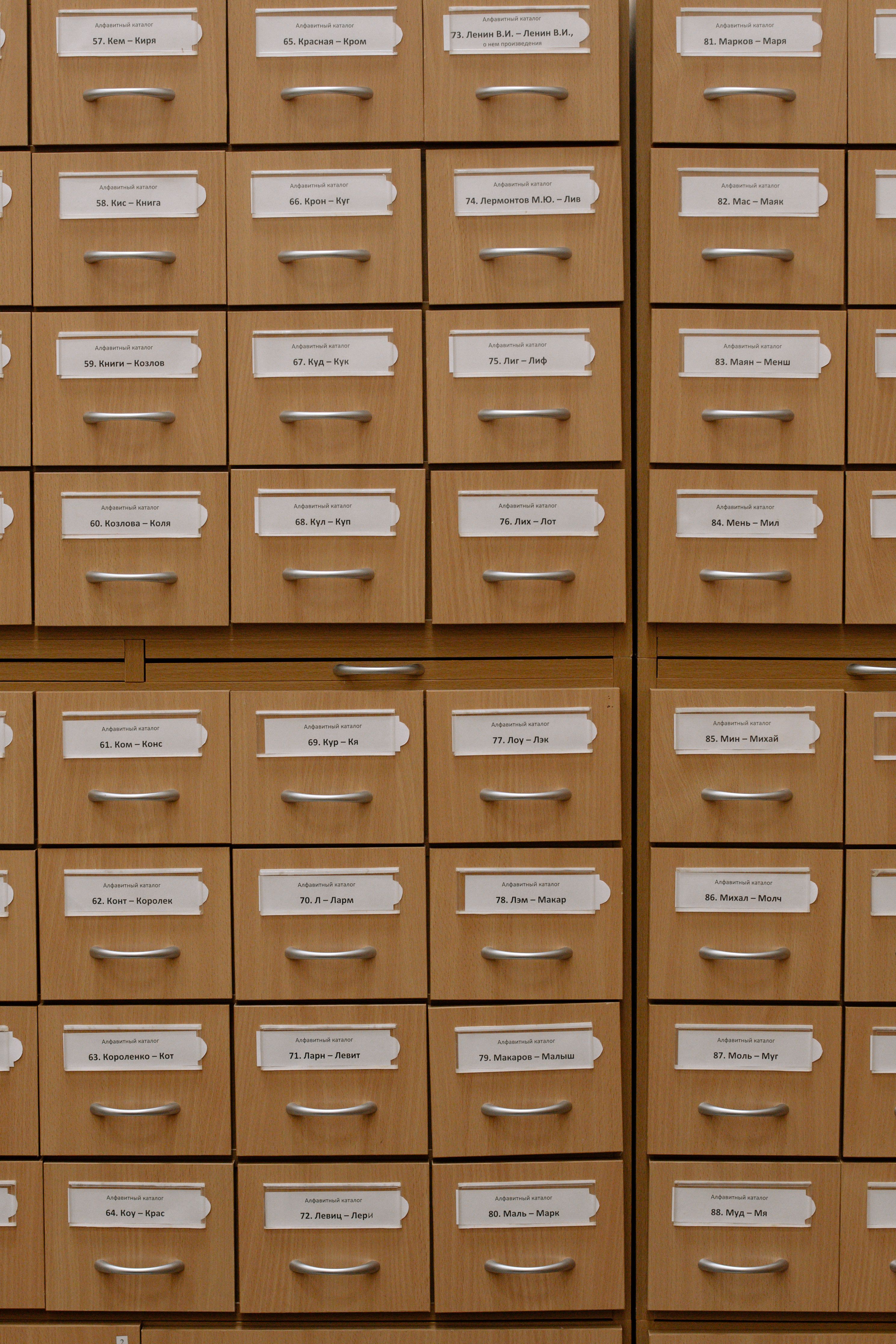 Vertical shot of labeled wooden file drawers for efficient organization