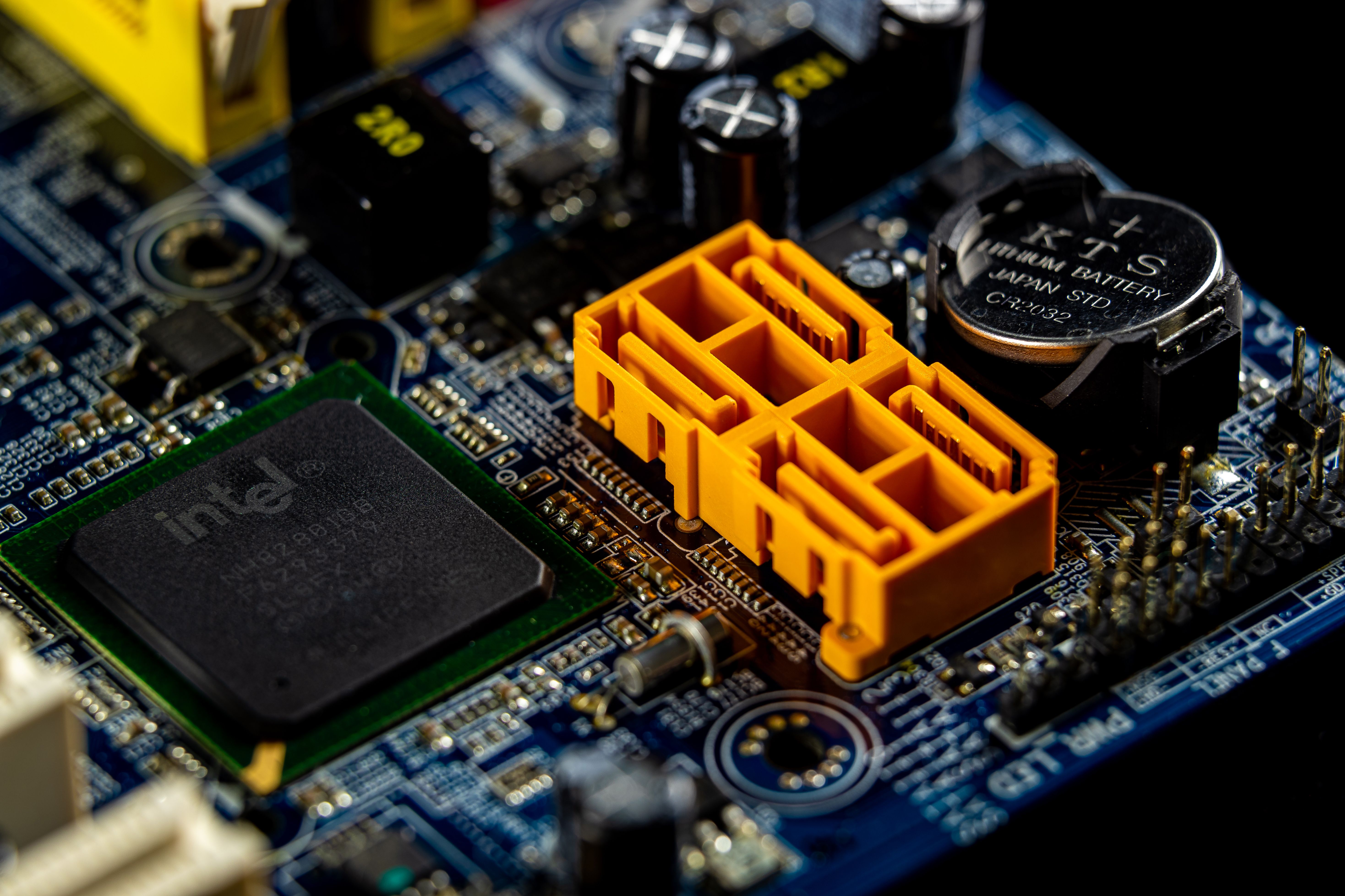 Detailed view of a computer motherboard showcasing an Intel microprocessor and electronic components.