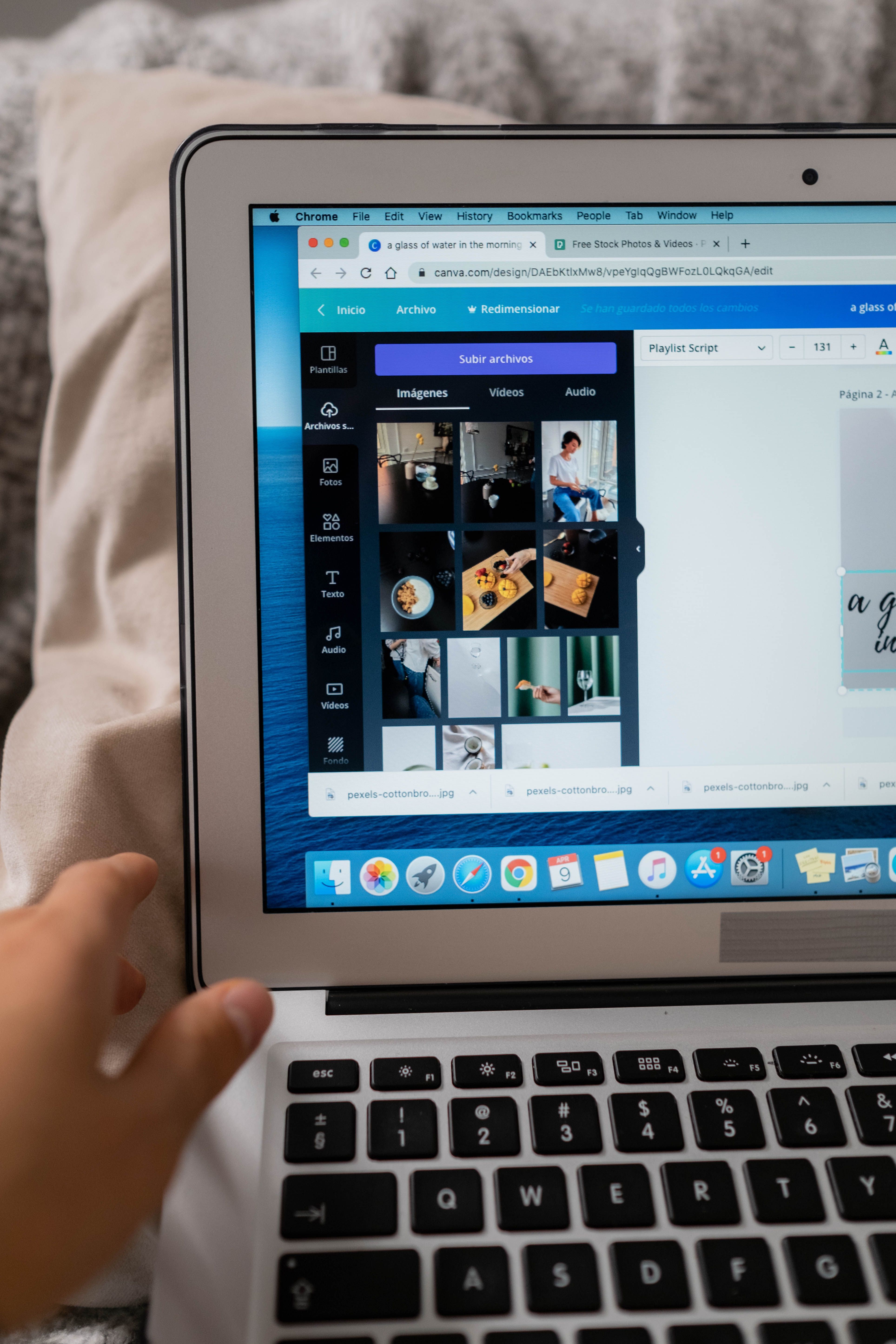 A person using design software on a laptop, showcasing creative work.
